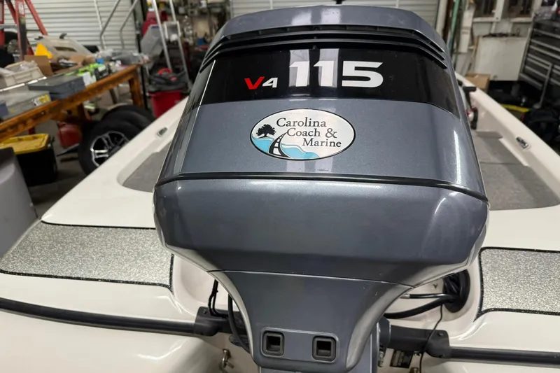 Slide: The Image of 2007 Skeeter SX180 boat with V4 115 engine in a workshop setting. - 8