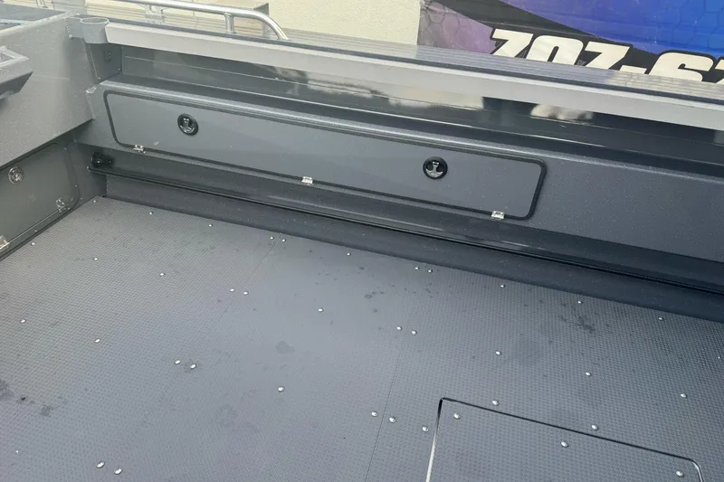 Slide: The Image of 2026 Duckworth 24 Pacific Pro boat interior with storage compartment and textured flooring. - 16