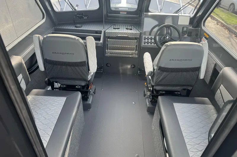 Slide: The Image of Interior of 2026 Duckworth 24 Pacific Pro boat with modern seating and control panel. - 22