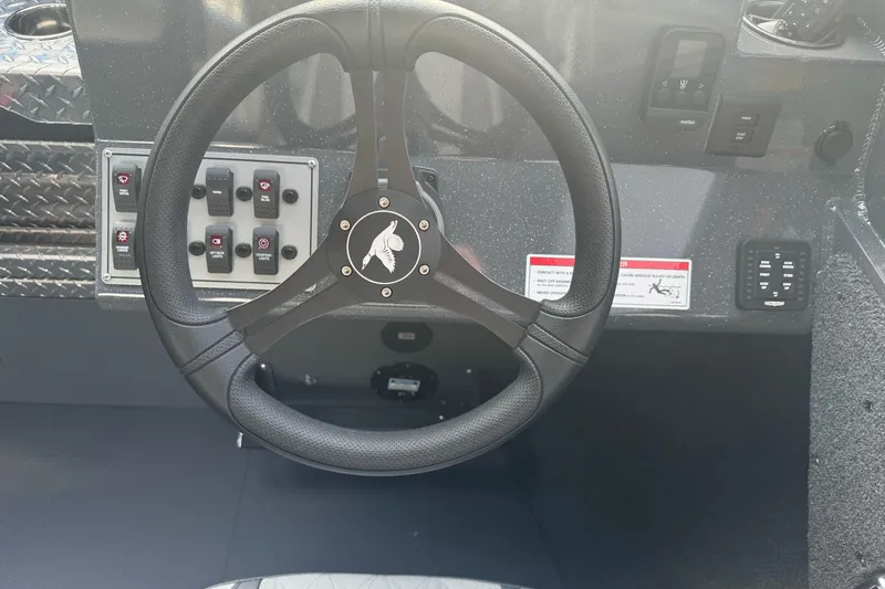 Slide: The Image of Steering wheel and control panel of 2026 Duckworth 24 Pacific Pro boat. - 25