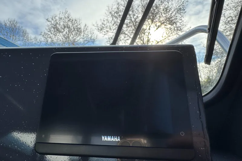 Slide: The Image of Yamaha display on 2026 Duckworth 24 Pacific Pro boat, with sunlight and trees in background. - 33