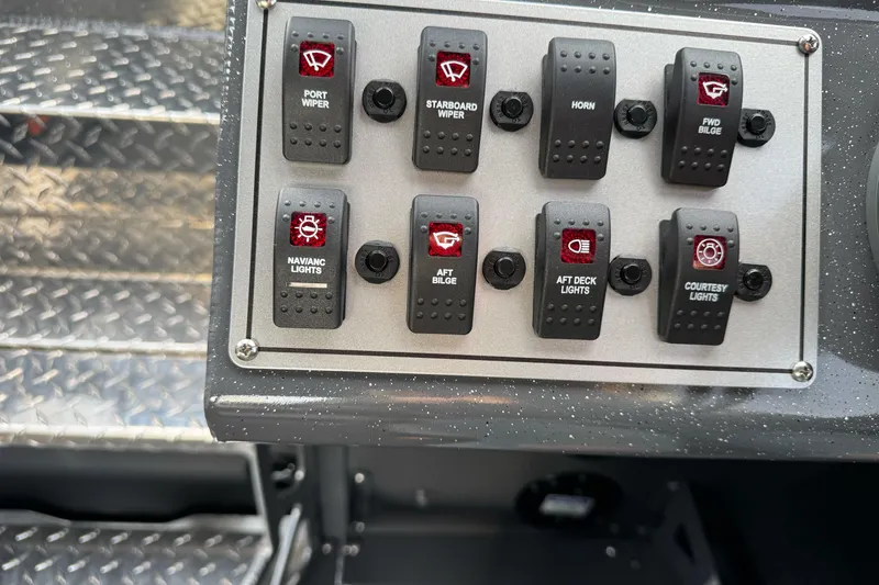 Slide: The Image of Control panel of 2026 Duckworth 24 Pacific Pro boat with labeled switches. - 35