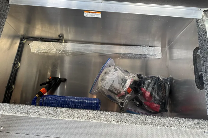 Slide: The Image of Storage compartment of 2026 Duckworth 24 Pacific Pro boat with tools and accessories. - 38
