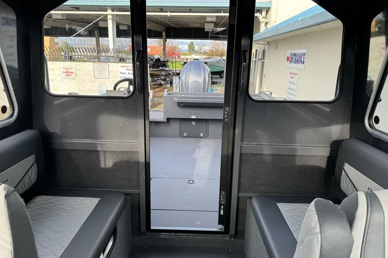 Slide: The Image of Interior view of 2026 Duckworth 24 Pacific Pro boat, featuring seating and rear deck. - 39