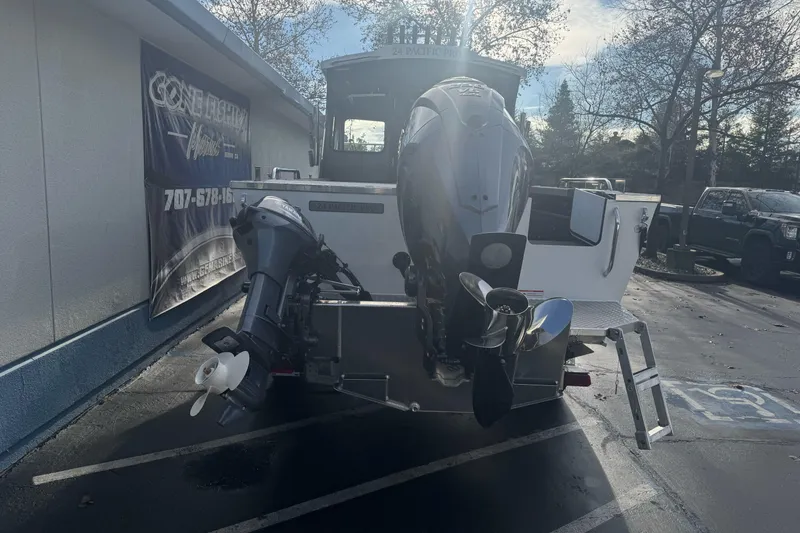 Slide: The Image of 2026 Duckworth 24 Pacific Pro boat with dual outboard motors in a parking lot. - 5