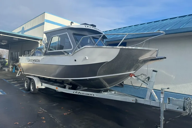 Slide: The Image of 2026 Duckworth 24 Pacific Pro boat on trailer, parked outside a building. - 7