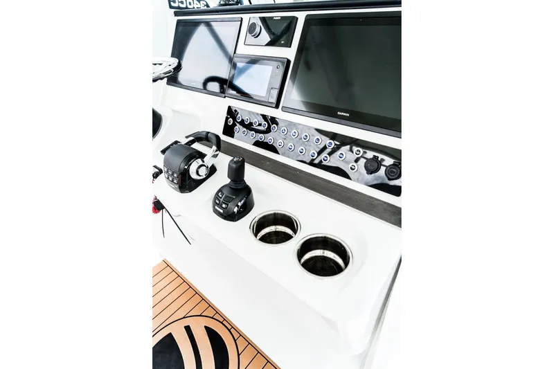 Slide: The Image of Edgewater 340CC 2026 boat dashboard with modern controls and navigation screens. - 11