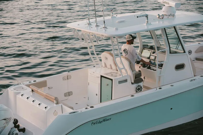 Slide: The Image of 2026 Edgewater 340CC boat on water, featuring modern design and advanced navigation equipment. - 13