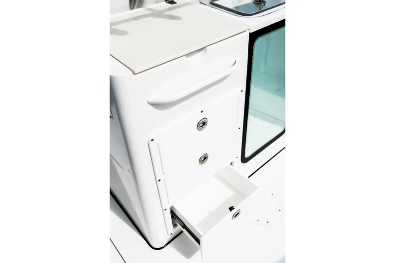 Slide: The Image of 2026 Edgewater 340CC boat interior with storage compartments and sleek design. - 14