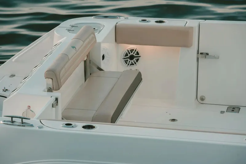 Slide: The Image of 2026 Edgewater 340CC boat interior with cushioned seating and speaker system. - 15