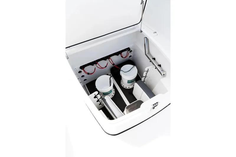 Slide: The Image of 2026 Edgewater 340CC boat storage compartment with buckets and wiring. - 22