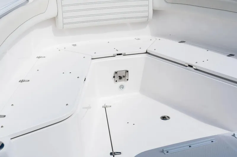 Slide: The Image of Interior view of 2026 Edgewater 340CC boat, showcasing sleek white seating and storage compartments. - 23