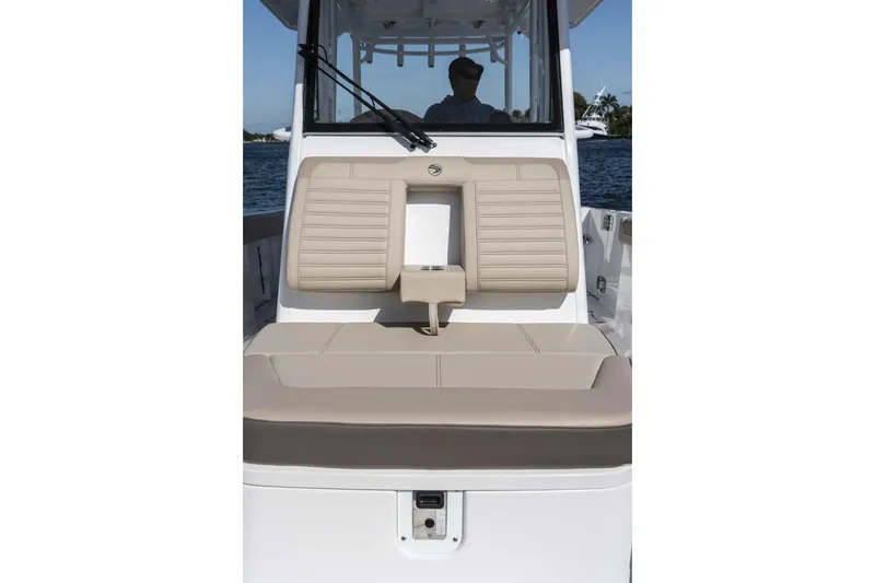 Slide: The Image of 2026 Edgewater 340CC boat interior with beige seating, on a sunny day. - 28