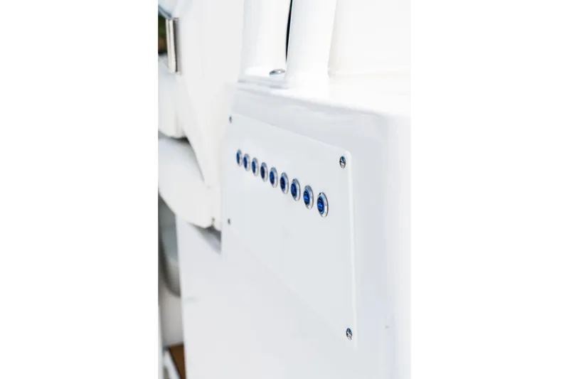 Slide: The Image of Close-up of 2026 Edgewater 340CC boat control panel with blue buttons. - 5