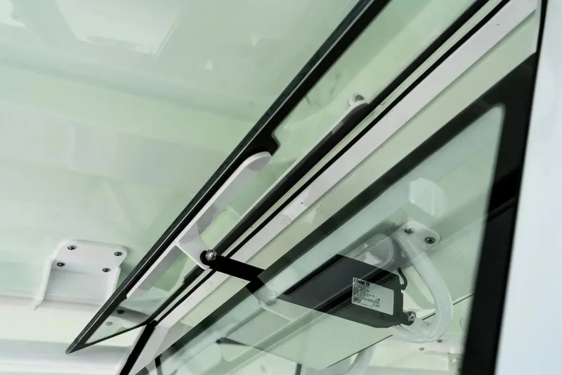 Slide: The Image of Close-up of 2026 Edgewater 340CC boat's glass panel and handle mechanism. - 6