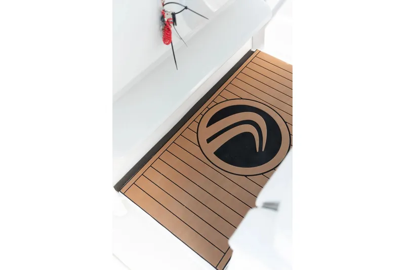 Slide: The Image of 2026 Edgewater 340CC boat deck with logo, featuring sleek wood-like design. - 7