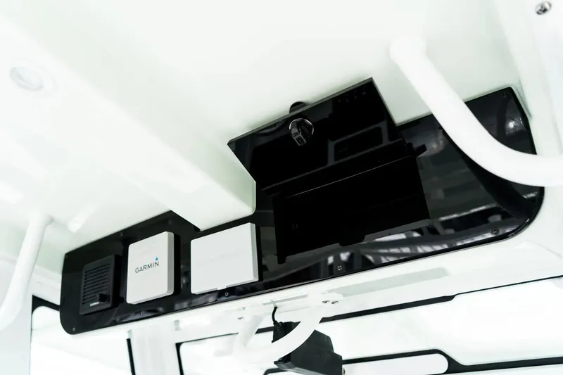 Slide: The Image of 2026 Edgewater 340CC boat console with Garmin electronics and storage compartment. - 9