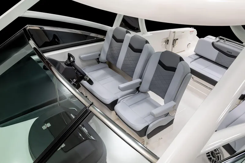 Slide: The Image of 2026 Chaparral 280 OSX boat interior with modern dashboard and seating at a boat show. - 5