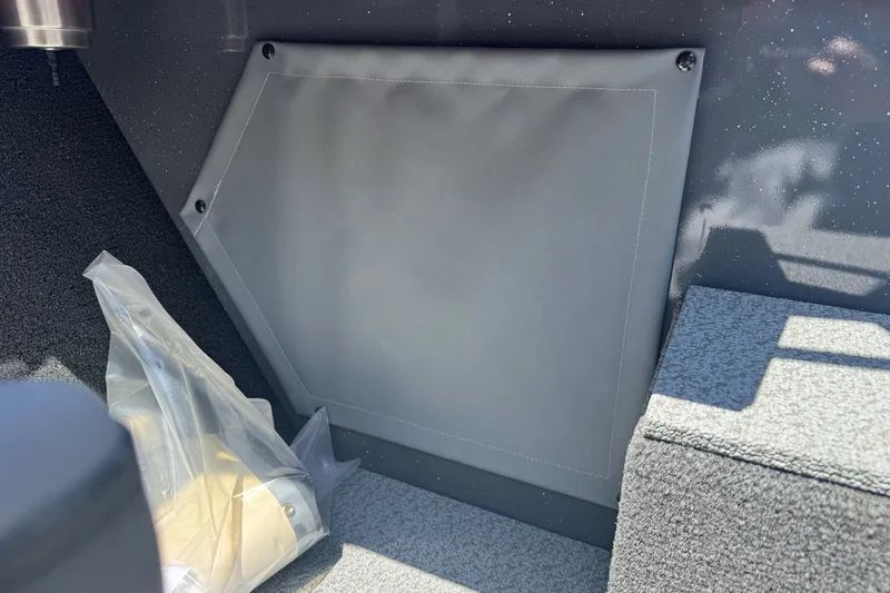Slide: The Image of Interior detail of 2026 Duckworth 18 Advantage boat, featuring storage compartment and carpeted flooring. - 19