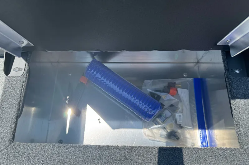 Slide: The Image of Storage compartment in a 2026 Duckworth 18 Advantage boat with tools and accessories. - 16