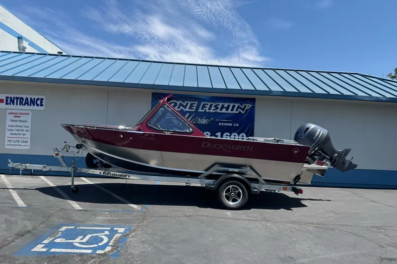 The Image of 2026 Duckworth 18 Advantage boat on trailer, parked outside a marine store. - 3