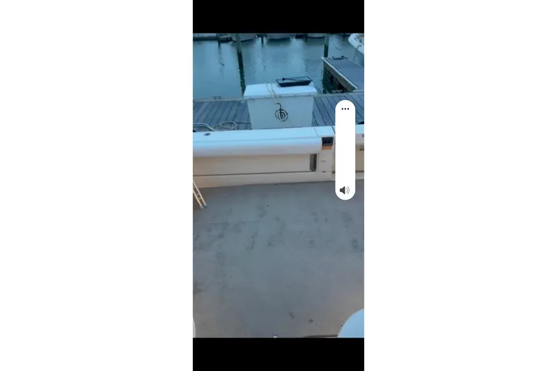 Slide: The Image of 1998 Sea Ray 340 Amberjack interior seating with white upholstery and storage area. - 10