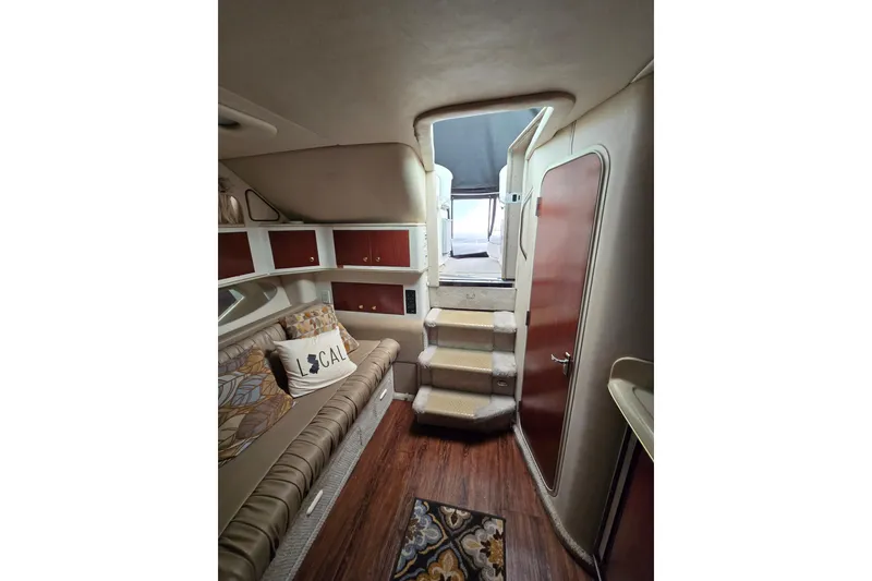 Slide: The Image of Interior of 1998 Sea Ray 340 Amberjack with cozy seating and wooden accents. - 25