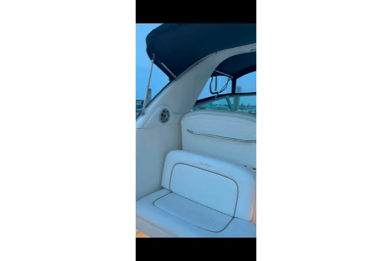 Slide: The Image of 1998 Sea Ray 340 Amberjack boat interior with white seating and blue canopy. - 35