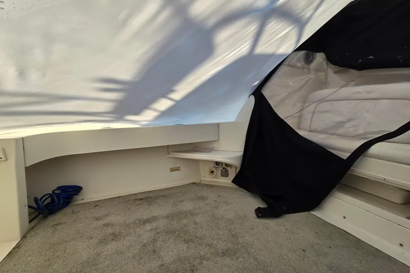 Slide: The Image of 1998 Sea Ray 340 Amberjack interior with carpet, seating, and coiled blue rope. - 39