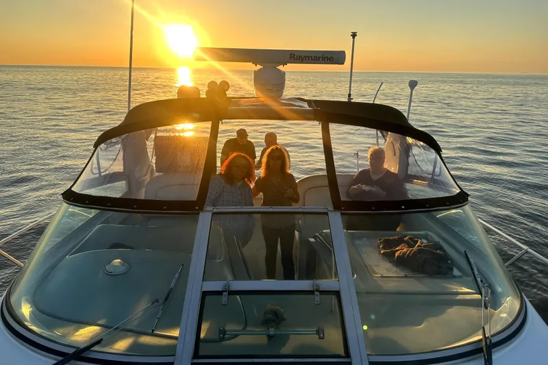 Slide: The Image of 1998 Sea Ray 340 Amberjack at sunset with people on deck, ocean view. - 4