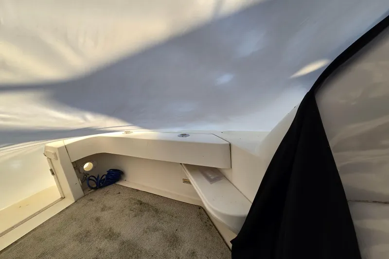 Slide: The Image of 1998 Sea Ray 340 Amberjack interior with carpeted floor and storage area. - 40