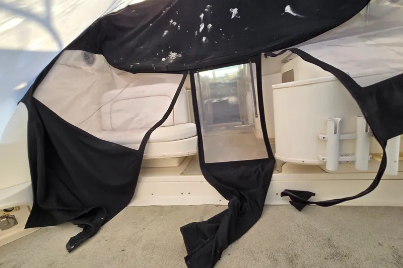 Slide: The Image of 1998 Sea Ray 340 Amberjack interior with black canvas cover and seating area. - 42