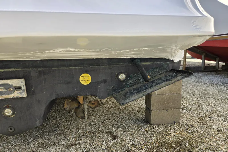 Slide: The Image of 1998 Sea Ray 340 Amberjack boat hull on blocks, showing propeller and rudder. - 56