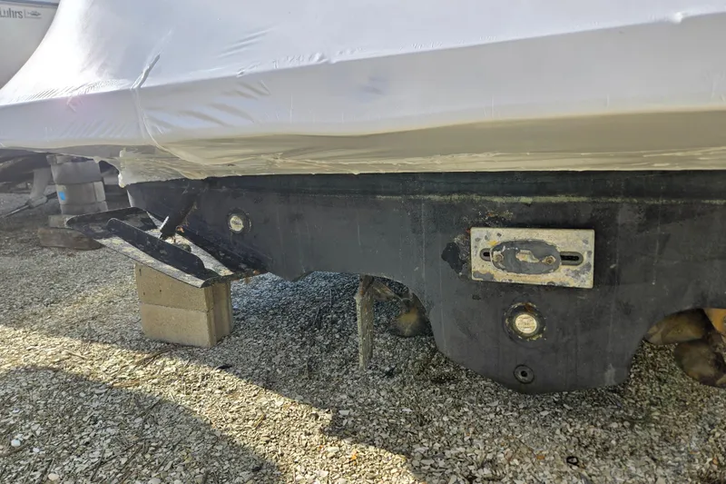 Slide: The Image of 1998 Sea Ray 340 Amberjack boat hull on blocks, covered in protective wrap. - 57