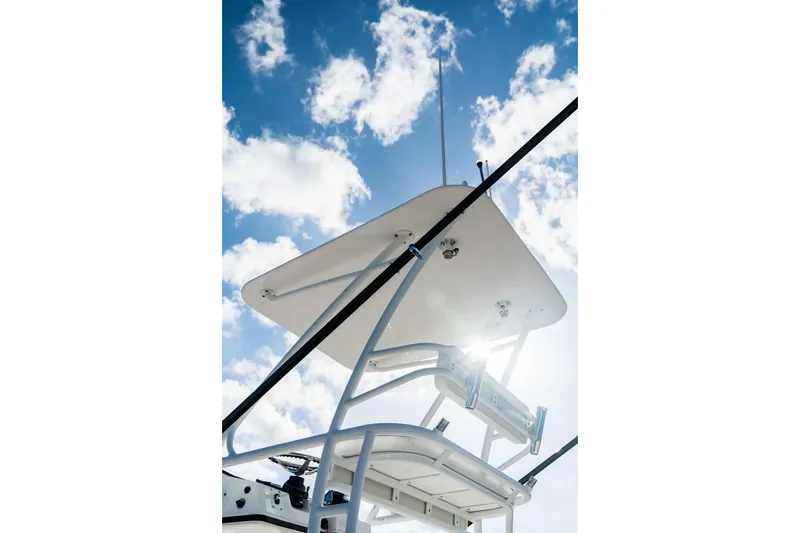 Slide: The Image of Edgewater 370CC 2026 boat tower against a bright blue sky with clouds. - 13