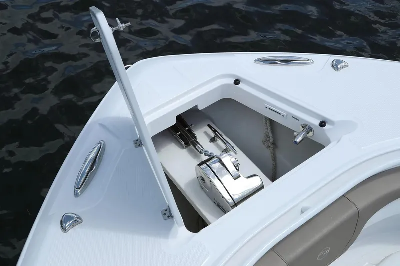 Slide: The Image of Open anchor compartment on 2026 Edgewater 370CC boat, showing anchor and chain. - 21