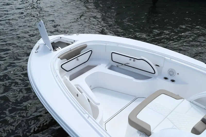 Slide: The Image of 2026 Edgewater 370CC boat interior with seating and storage, on calm water. - 4