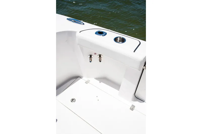 Slide: The Image of 2026 Edgewater 370CC boat interior detail with cup holders and water view. - 6