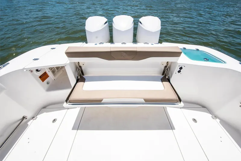 Slide: The Image of 2026 Edgewater 370CC boat with foldable seating and triple outboard motors on the water. - 8