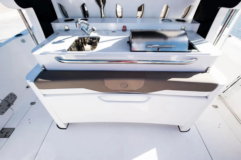 Slide: The Image of 2026 Edgewater 370CC boat with onboard sink and grill station. - 9