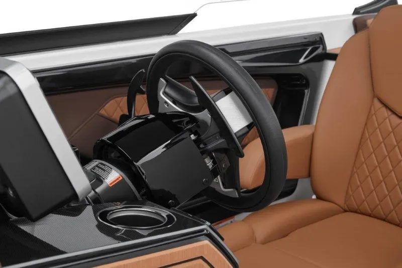 Slide: The Image of Luxury interior of 2026 Yamaha Boats 252SD, featuring sleek steering wheel and tan leather seating. - 16