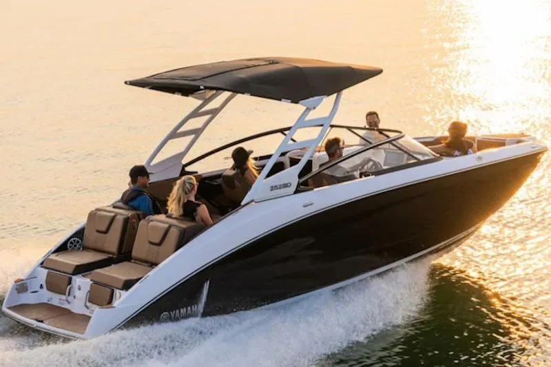 Slide: The Image of 2026 Yamaha Boats 252SD cruising on water at sunset with passengers onboard. - 3