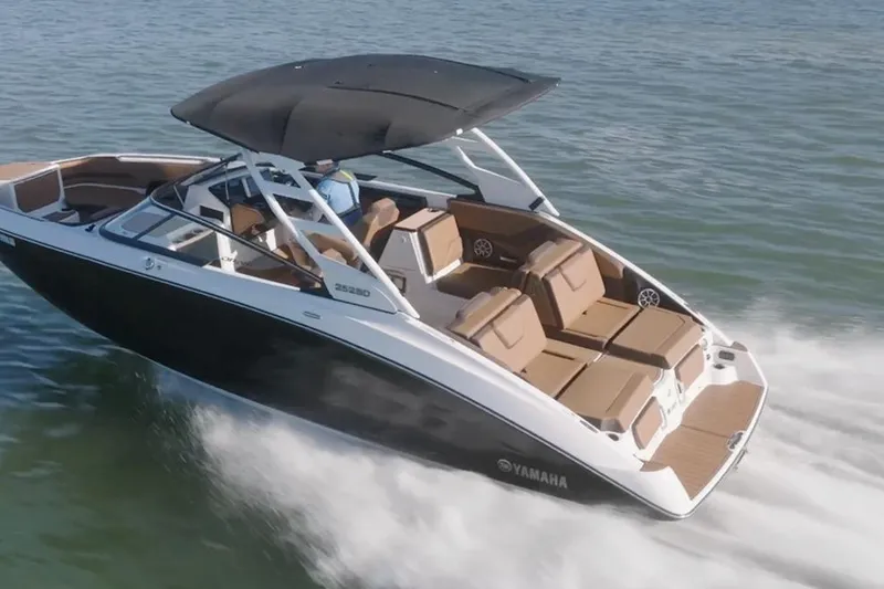 Slide: The Image of 2026 Yamaha Boats 252SD cruising on water, featuring sleek design and spacious seating. - 4