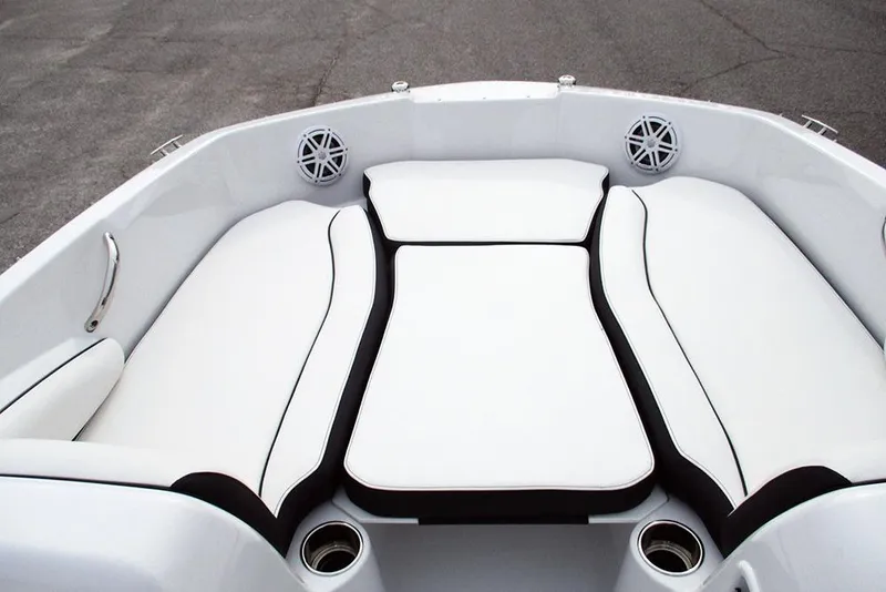 Slide: The Image of 2026 Stingray 182 SC boat interior with white cushioned seating and cup holders. - 10