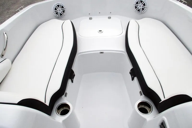 Slide: The Image of 2026 Stingray 182 SC boat interior with white cushioned seating and cup holders. - 15