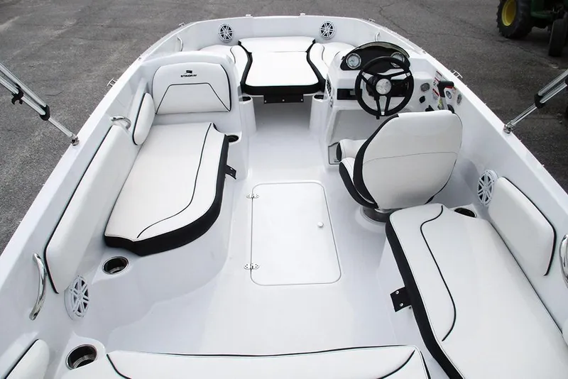 Slide: The Image of 2026 Stingray 182 SC boat interior with white seating and steering console. - 16