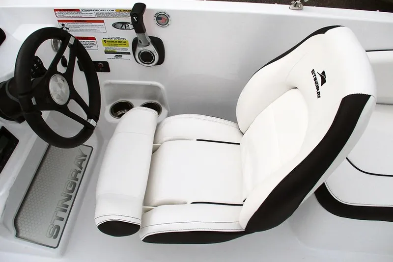Slide: The Image of 2026 Stingray 182 SC boat interior with steering wheel and white cushioned seat. - 20