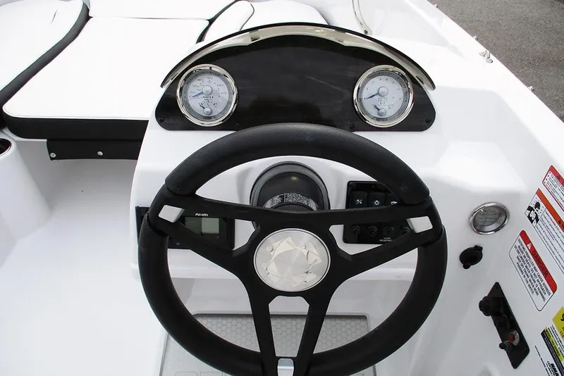 Slide: The Image of 2026 Stingray 182 SC boat dashboard with steering wheel and gauges. - 21