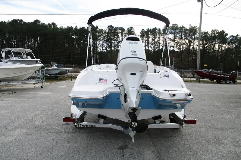 Slide: The Image of 2026 Stingray 182 SC boat with outboard motor on trailer, parked outdoors. - 8