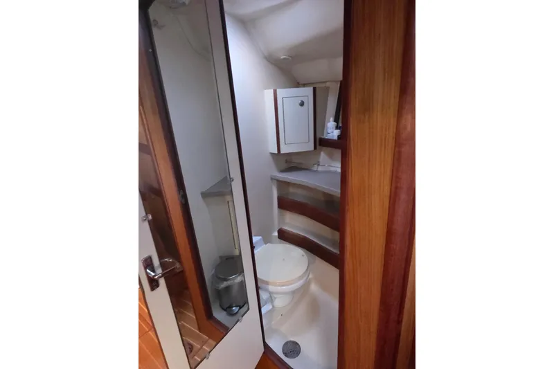 Slide: The Image of Interior of a 2000 Hunter 460 sailboat with cozy seating and wooden finishes. - 12